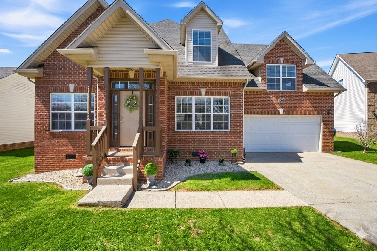 a front view of a house with a yard and garage