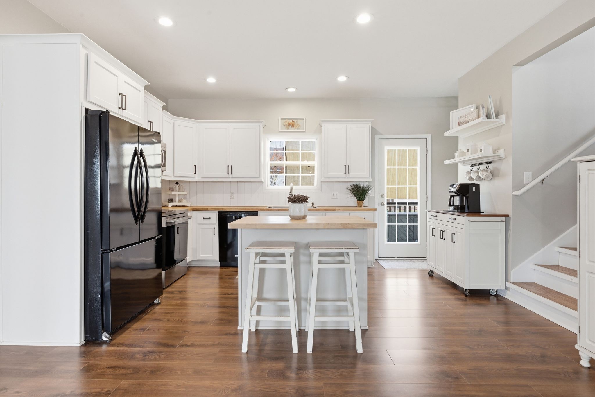 1723 Stephenson Lane Spring Hill, TN 37174 - Photo 19 of 48 a kitchen with stainless steel appliances kitchen island granite countertop a refrigerator a stove a sink dishwasher and white cabinets with wooden floor