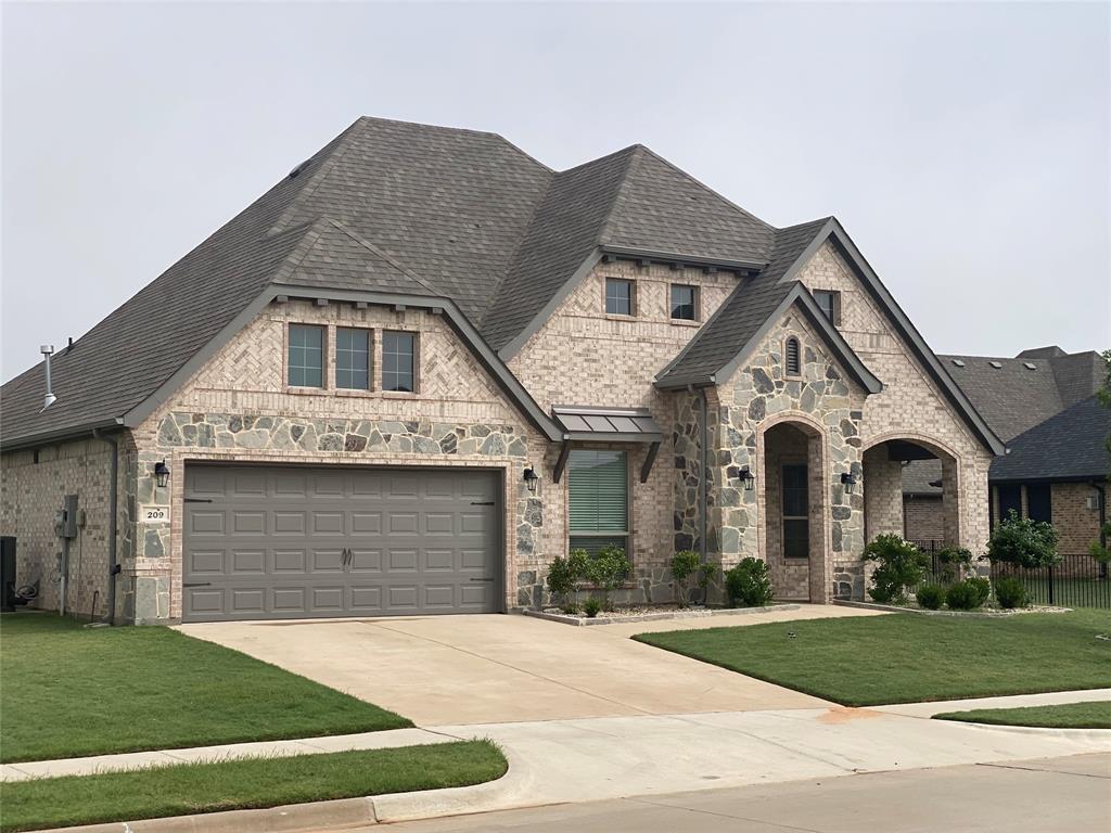 209 Johnson Street Granbury, TX 76048 - Photo 3 of 40 French provincial home featuring a garage and a front yard