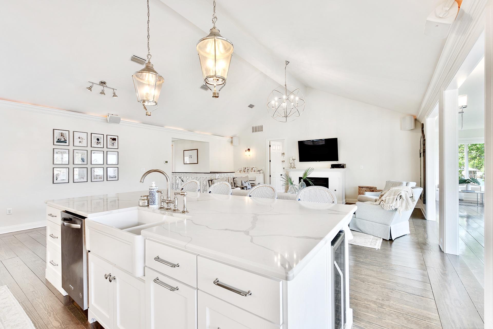 368 West Harborview Road Santa Rosa Beach, FL 32459 - Photo 22 of 60 a large white kitchen with a sink and living room view