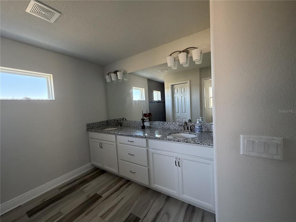 587 North Riva Ridge Path Inverness, FL 34453 - Photo 12 of 44 a bathroom with a double vanity sink and a mirror