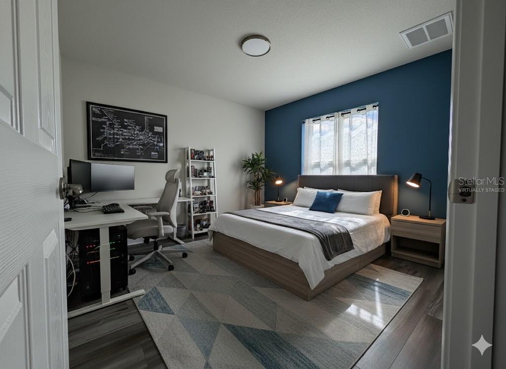 587 North Riva Ridge Path Inverness, FL 34453 - Photo 16 of 44 a bedroom with a bed and wooden floor