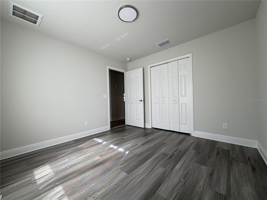 587 North Riva Ridge Path Inverness, FL 34453 - Photo 18 of 42 a view of an empty room with wooden floor