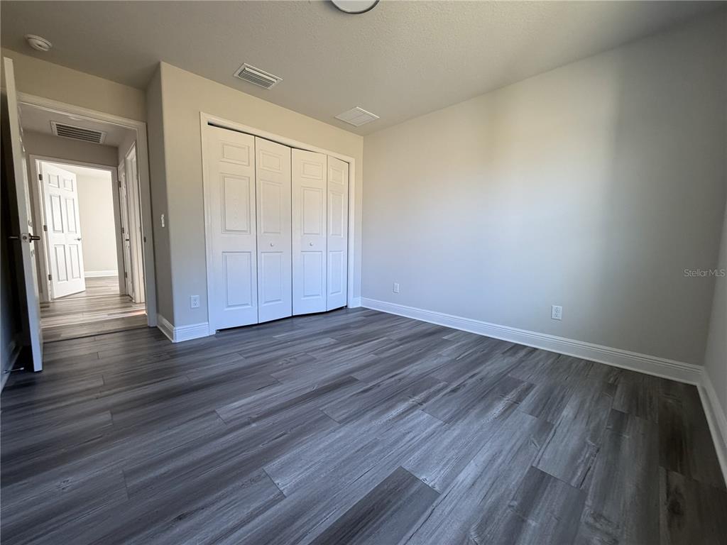587 North Riva Ridge Path Inverness, FL 34453 - Photo 18 of 44 a view of an empty room and wooden floor
