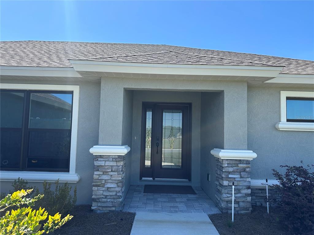 587 North Riva Ridge Path Inverness, FL 34453 - Photo 3 of 44 a view of a hallway with a chair and a potted plant
