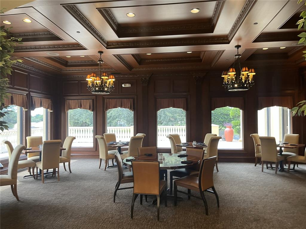 587 North Riva Ridge Path Inverness, FL 34453 - Photo 41 of 44 a view of a dining room with furniture a chandelier and large windows