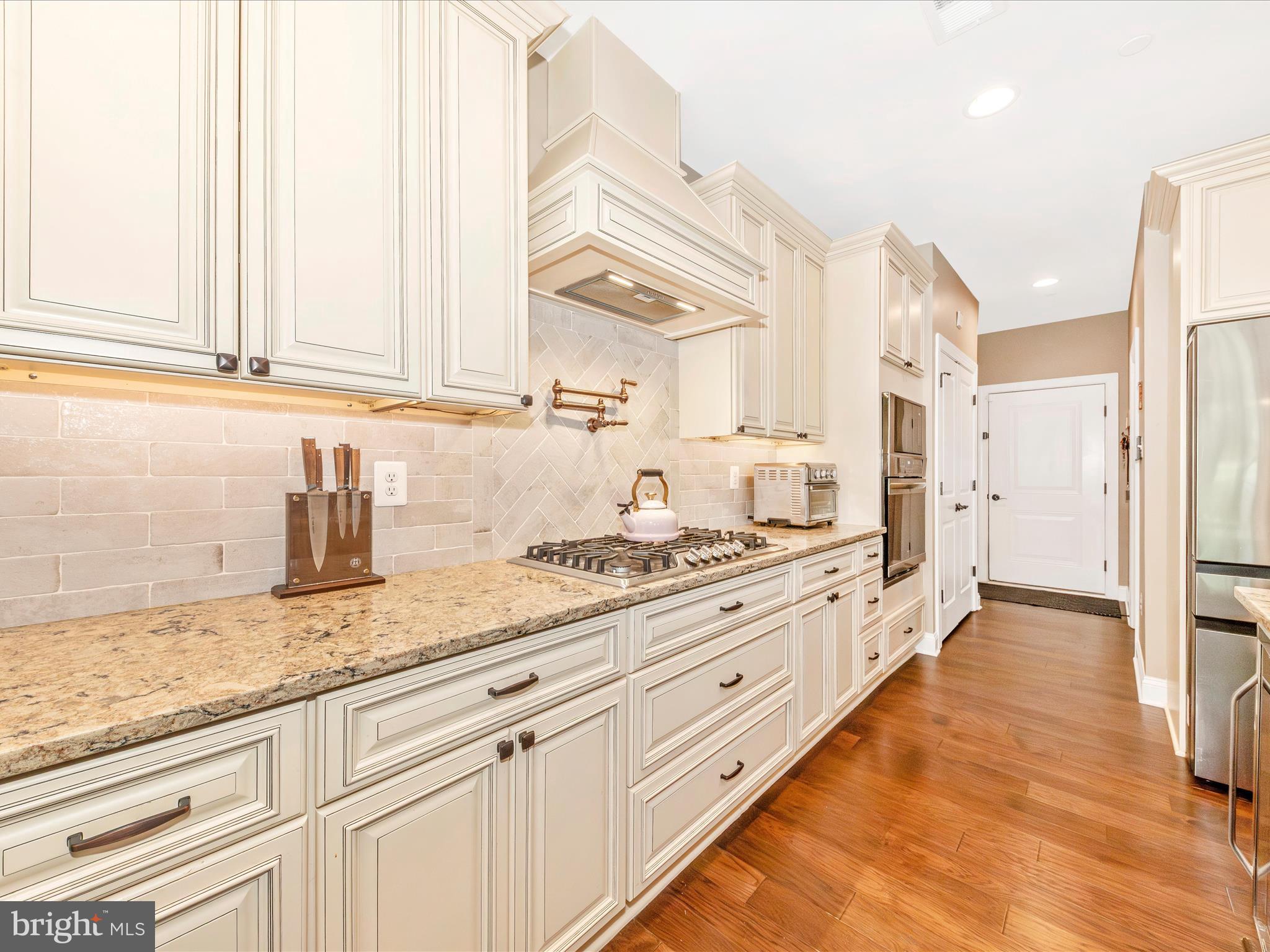 7788 Old Receiver Road Frederick, MD 21702 - Photo 17 of 51 a kitchen with granite countertop white cabinets and appliances