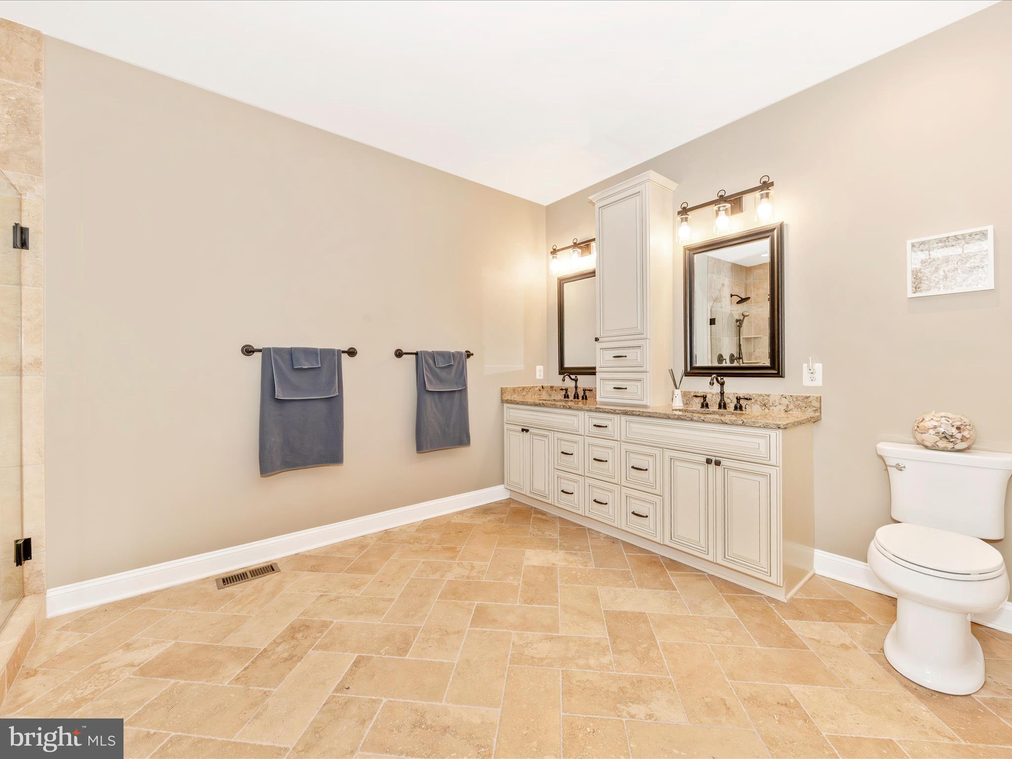 7788 Old Receiver Road Frederick, MD 21702 - Photo 23 of 51 a spacious bathroom with a granite countertop sink mirror and toilet
