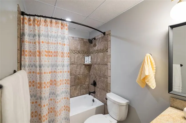 a bathroom with a toilet sink and shower