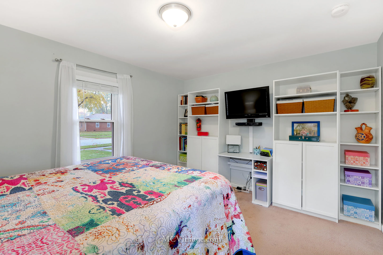 5830 108th Place Chicago Ridge, IL 60415 - Photo 18 of 28 a bedroom with a bed and a flat tv screen on dresser