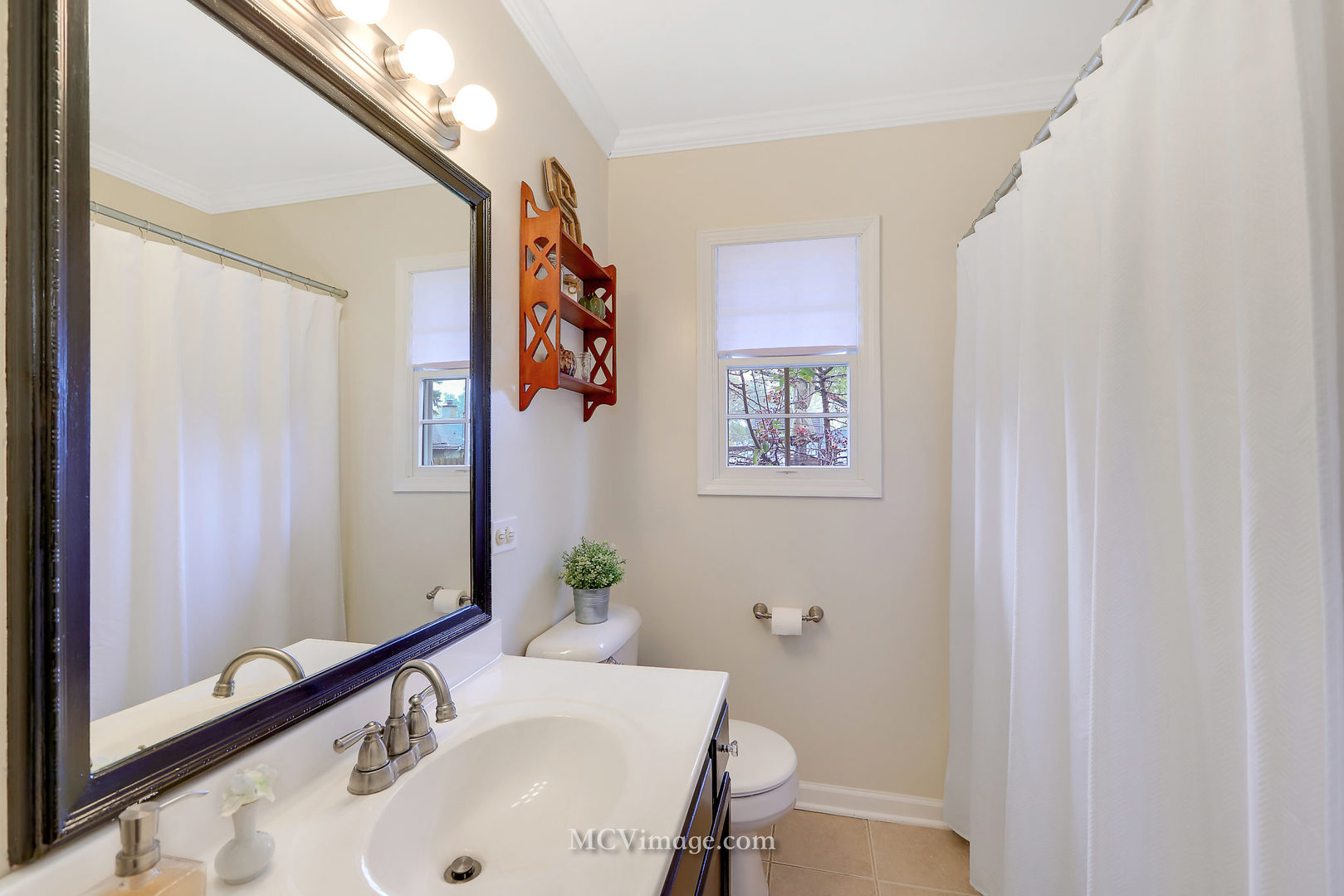 5830 108th Place Chicago Ridge, IL 60415 - Photo 19 of 28 a bathroom with a sink mirror and a toilet