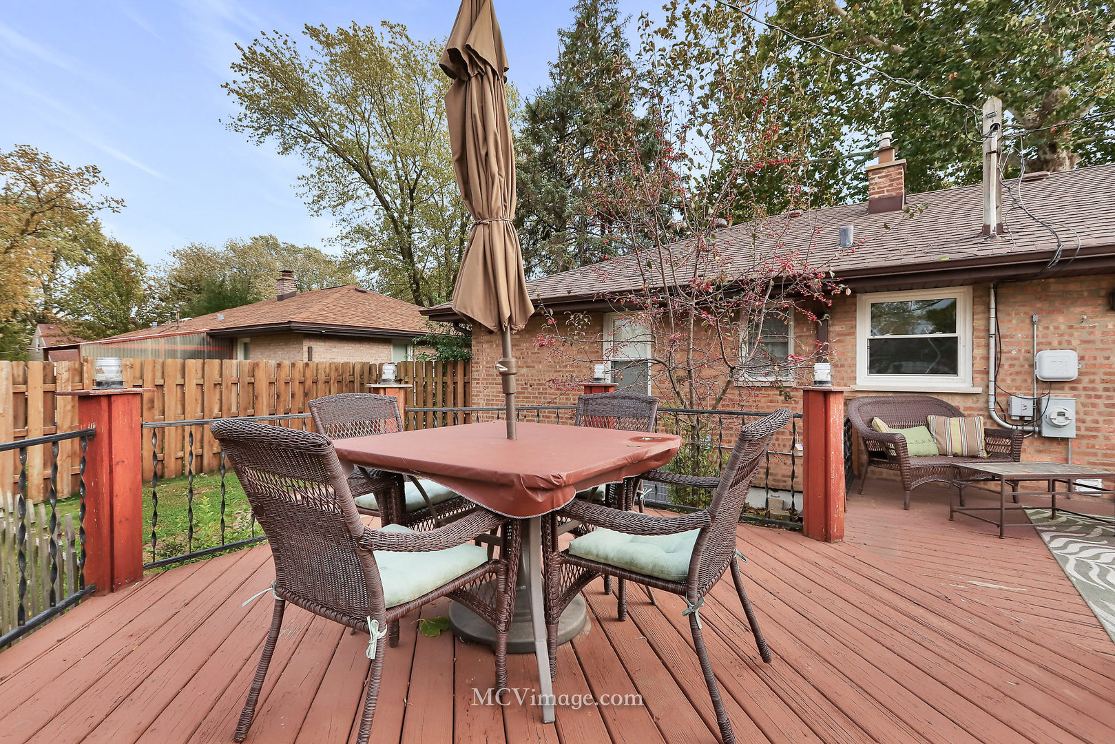 5830 108th Place Chicago Ridge, IL 60415 - Photo 23 of 28 a patio with wooden table and chairs