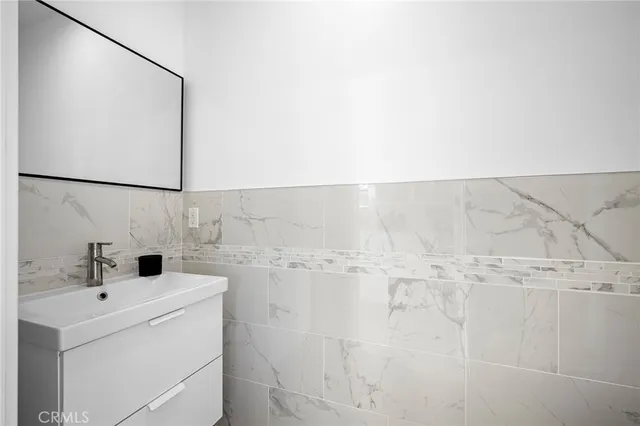 a bathroom with a sink and mirror