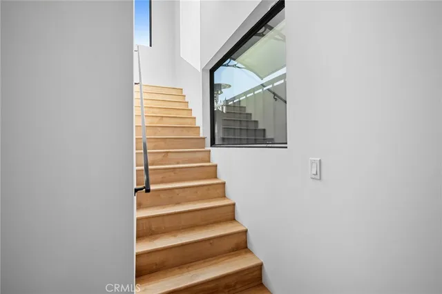 a bed sitting in a spacious bedroom next to a window
