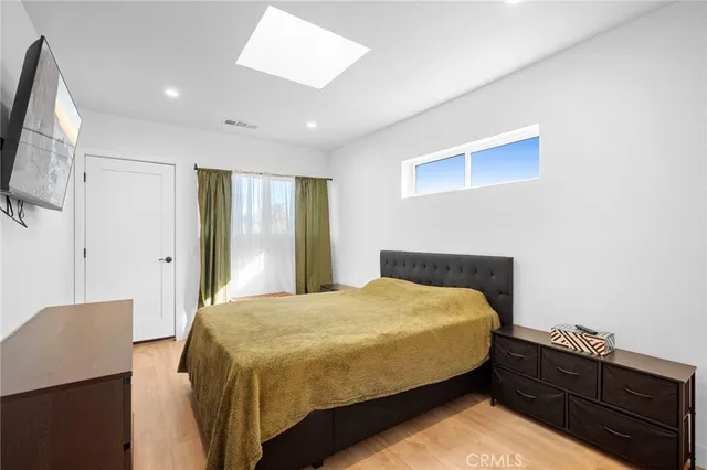 a bedroom with a bed and a painting on the wall