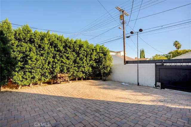 a view of backyard with a table and chair and wooden fence