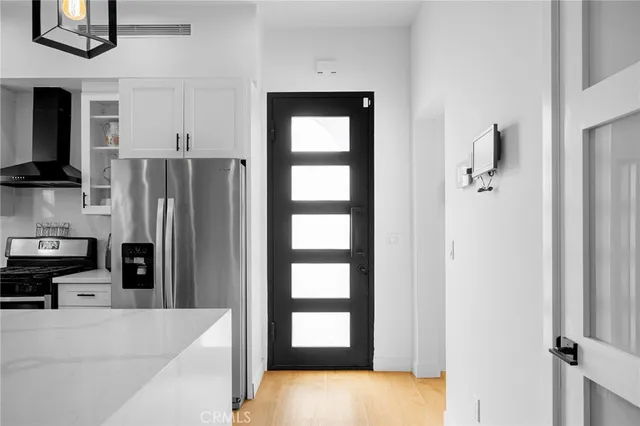a view of hallway with stairs and furniture