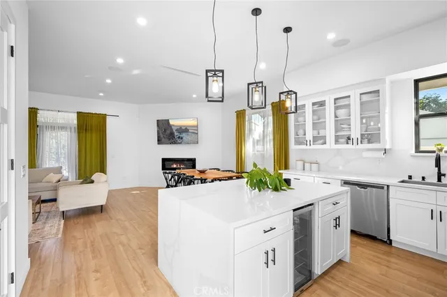 a kitchen with a sink stove and wooden floor