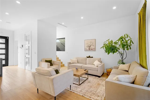 a living room with furniture and a potted plant