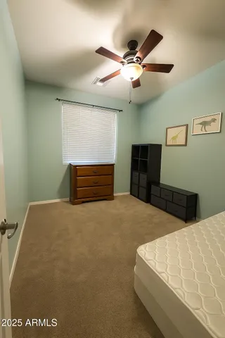 a bedroom with a bed and a dresser
