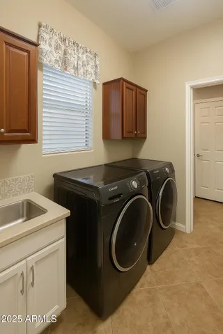 a utility room with sink dryer and washer