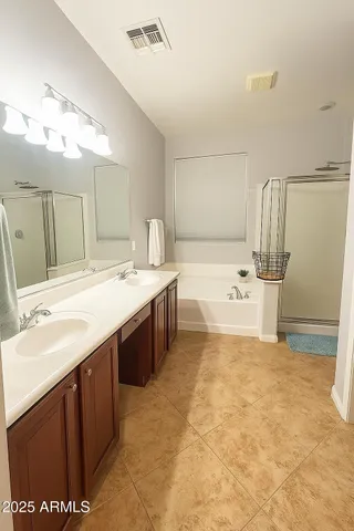 a spacious bathroom with a sink mirror and a bath tub