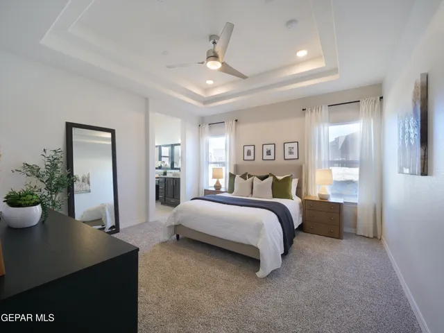 a bathroom with a granite countertop sink a large mirror and a window