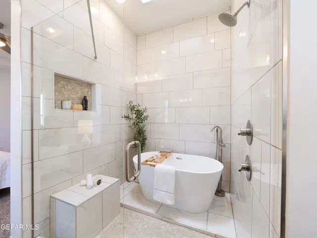 a spacious bedroom with a bed and window