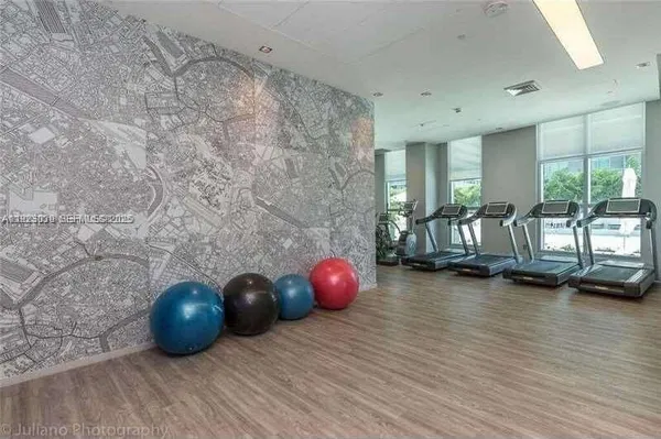 a living room with furniture a rug and a large window