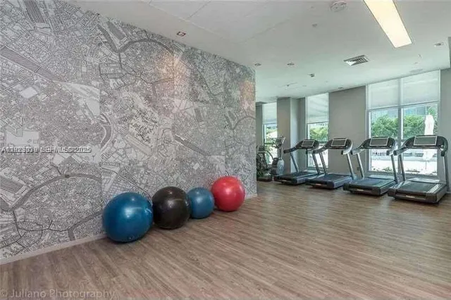 a living room with furniture a rug and a large window