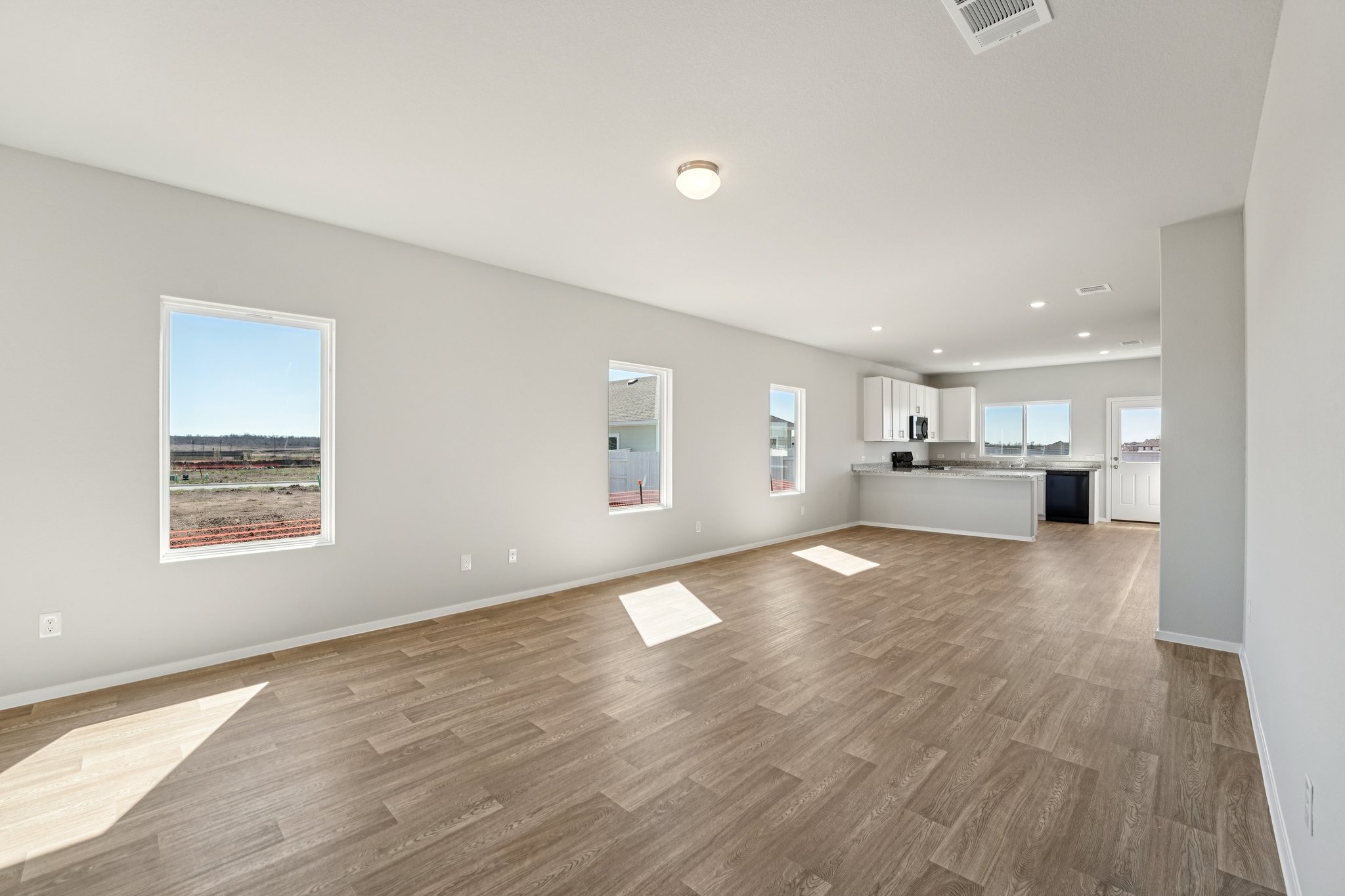 136 Summer Drive Elgin, TX 78621 - Photo 11 of 35 From Family Room to Open Concept Kitchen
