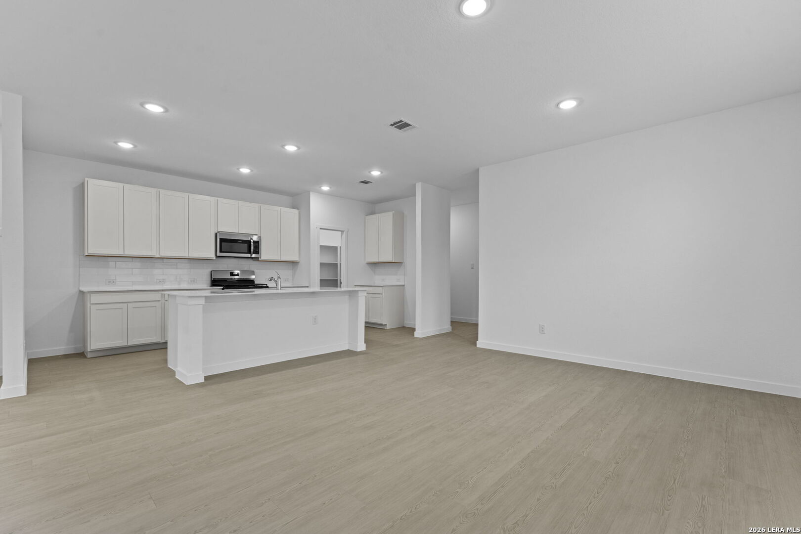 2307 Fort Davis Pass Marion, TX 78124 - Photo 22 of 31 a large white kitchen with white cabinets and stainless steel appliances