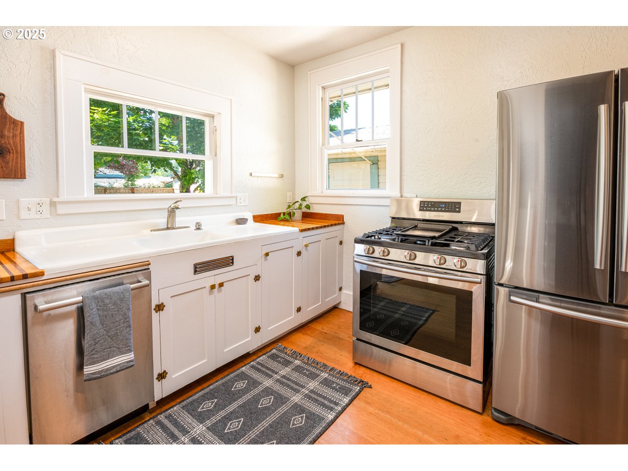 945 B Street Springfield, OR 97477 - Photo 15 of 35 a kitchen with stainless steel appliances a stove a sink and a refrigerator
