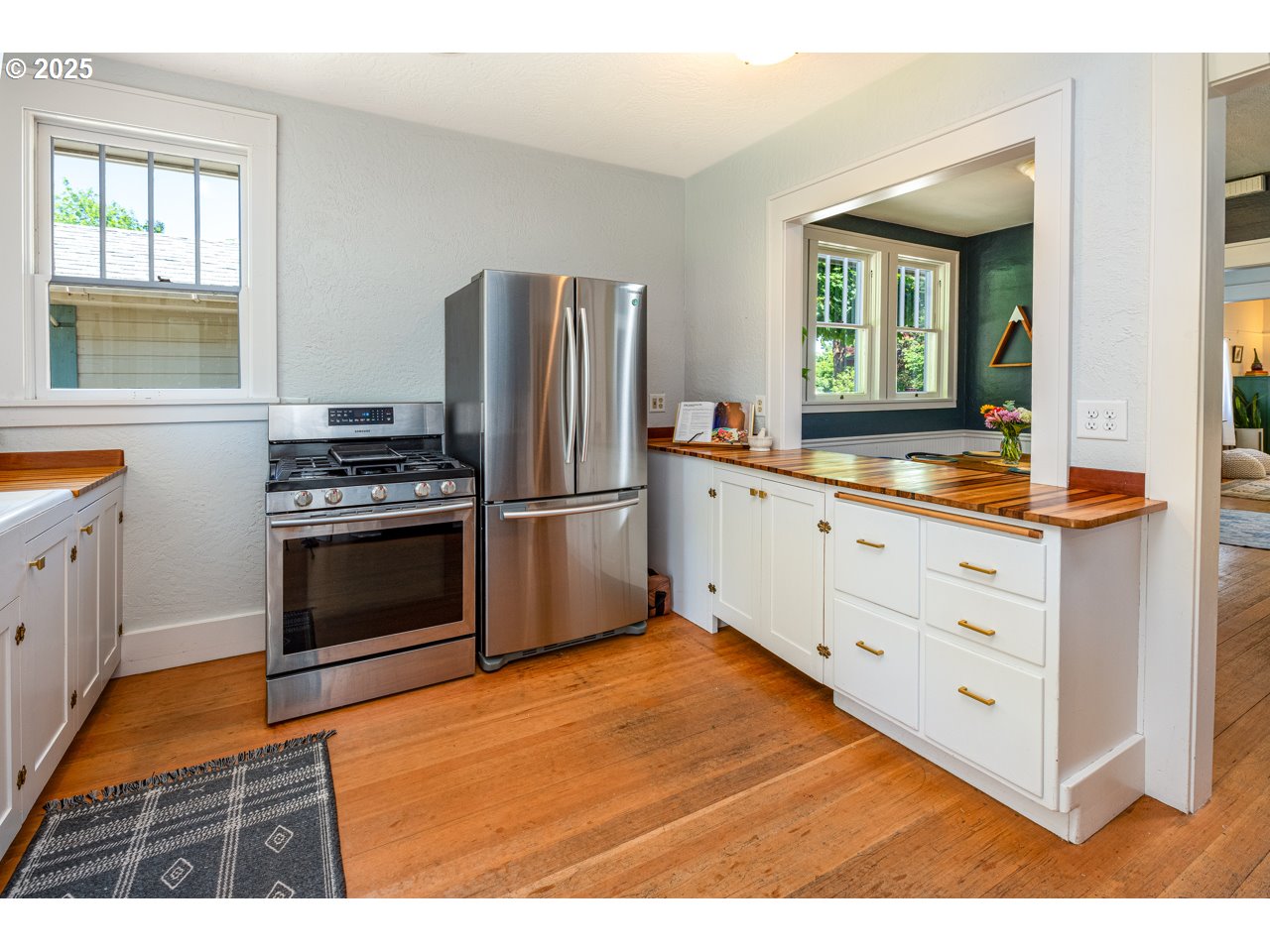 945 B Street Springfield, OR 97477 - Photo 16 of 35 a kitchen with stainless steel appliances kitchen island granite countertop a refrigerator and a stove top oven