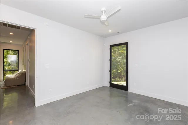 an empty room with windows and closet