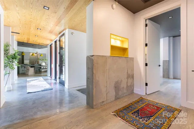 a living room with a rug and a table