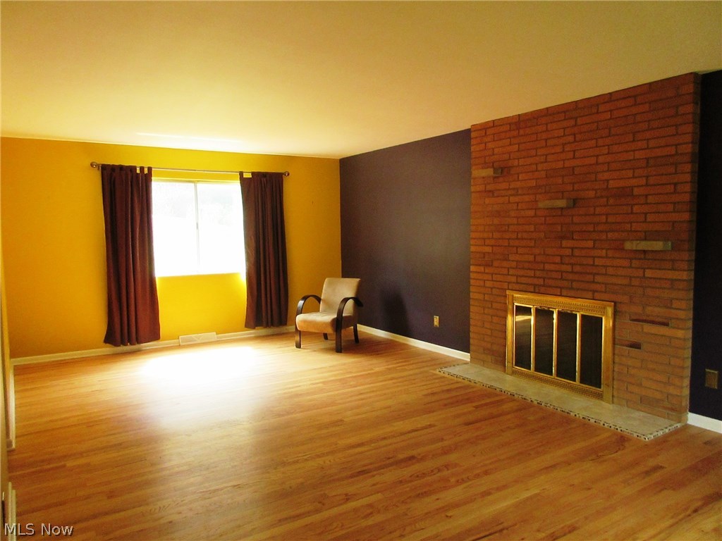 3397 Darrow Road Stow, OH 44224 - Photo 3 of 30 Massive living room wit wall brick fireplace, an solid hard wood floors.