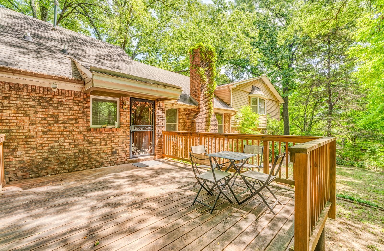 8651 Baylor Road Bartlett, TN 38002 - Photo 18 of 29 a view of a brick house with large trees and wooden fence