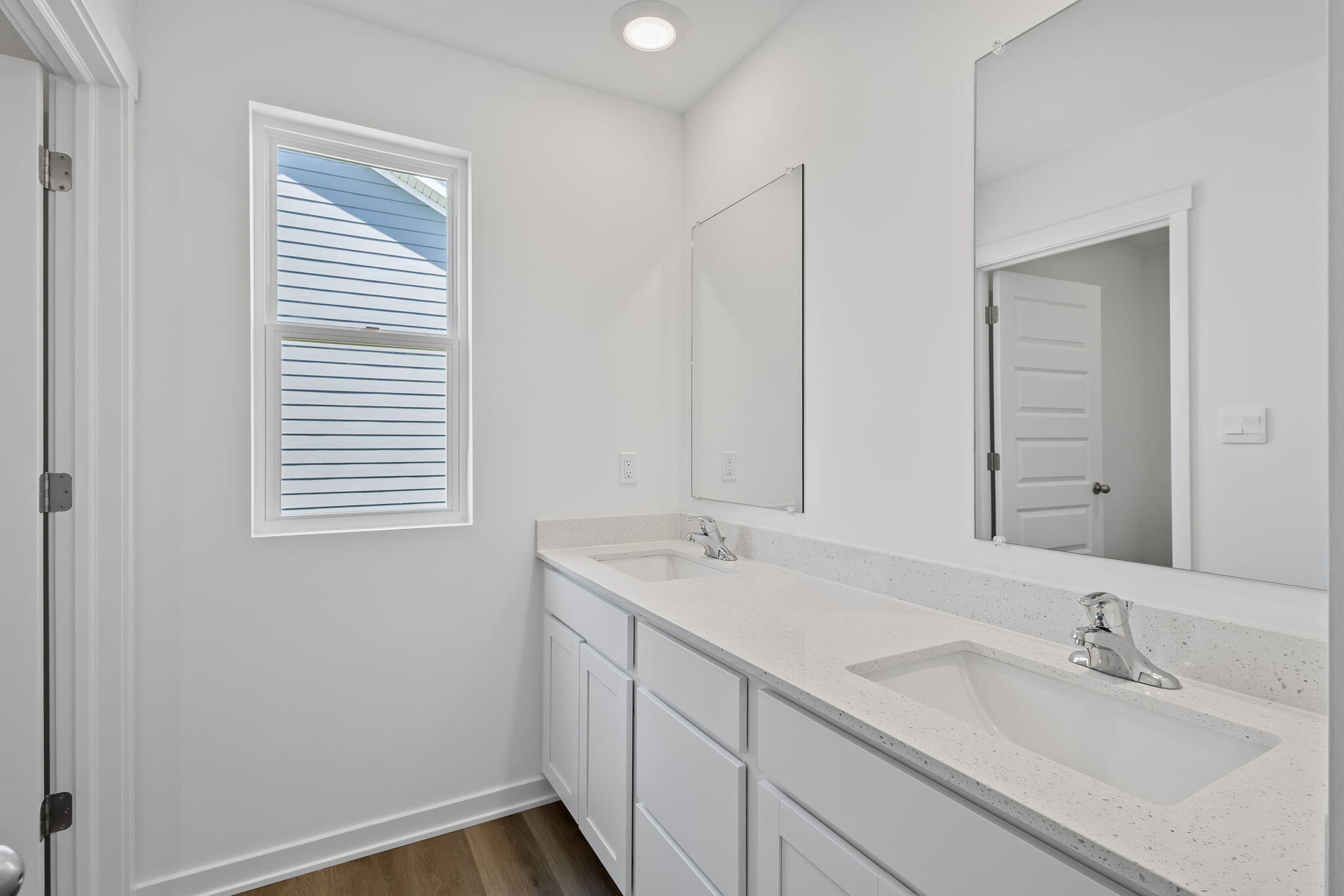 7883 West 105th Avenue Crown Point, IN 46307 - Photo 23 of 26 a bathroom with a sink and a mirror