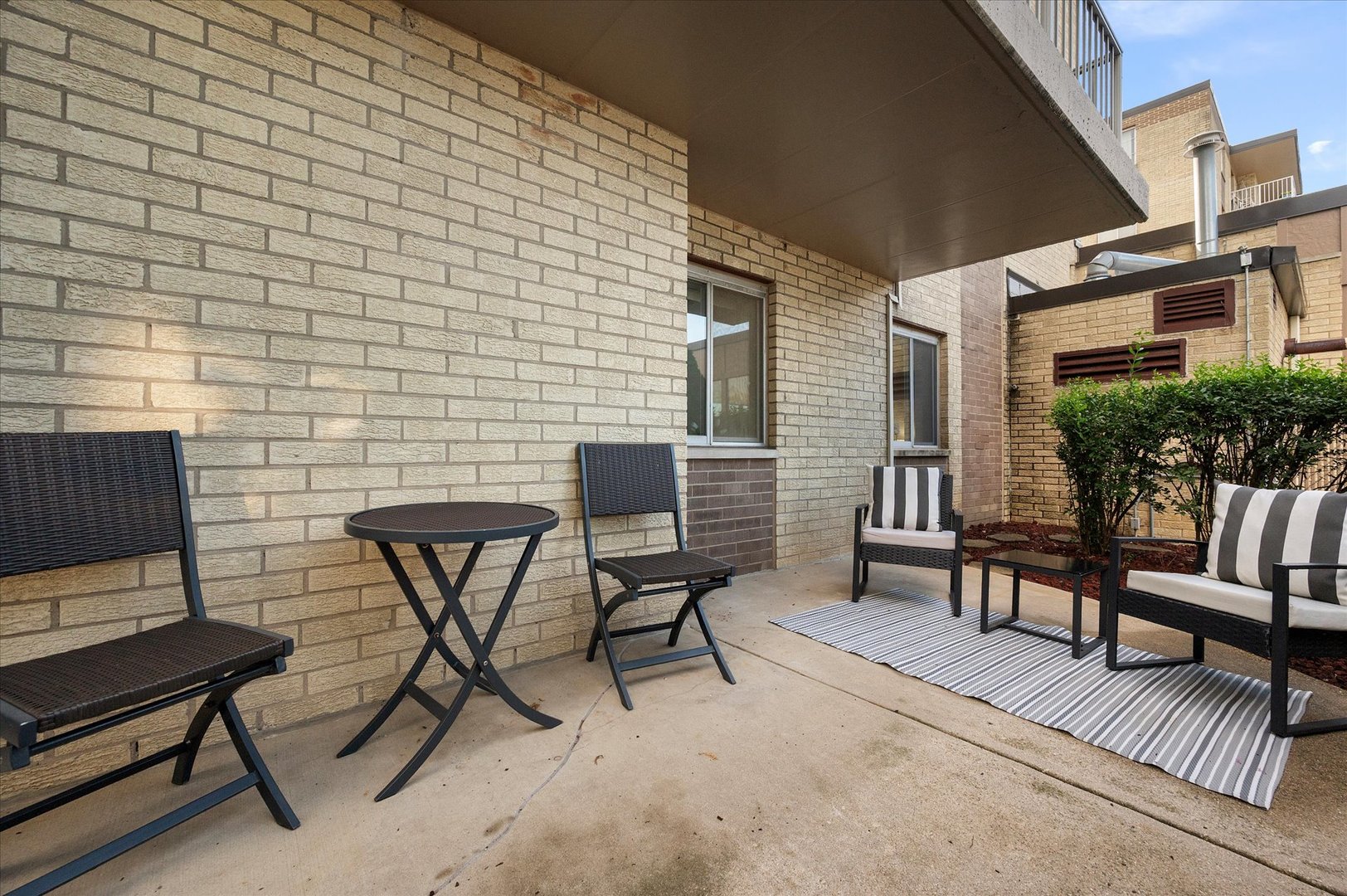 100 West Butterfield Road, Unit 101N Elmhurst, IL 60126 - Photo 19 of 27 a view of a chairs and table in a patio
