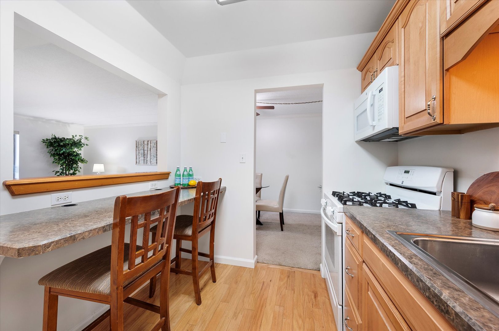 100 West Butterfield Road, Unit 101N Elmhurst, IL 60126 - Photo 9 of 27 a kitchen with stainless steel appliances granite countertop a table chairs stove and sink