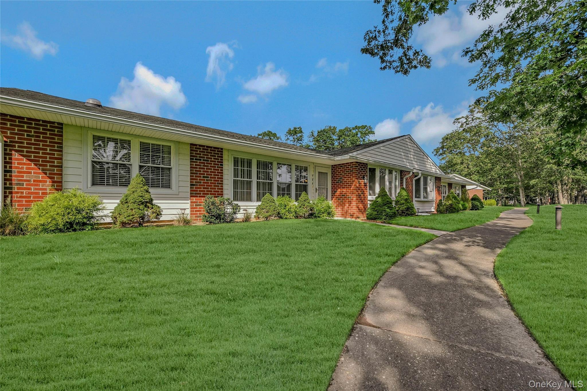 Ranch-style home featuring brick siding and a front yard