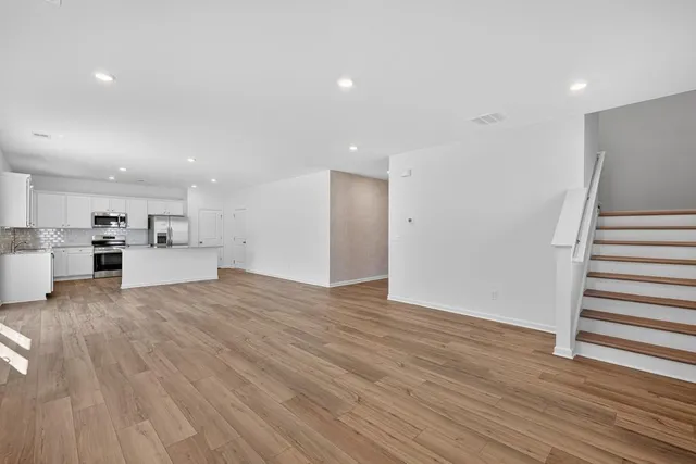 a view of kitchen with wooden floor and electronic appliances