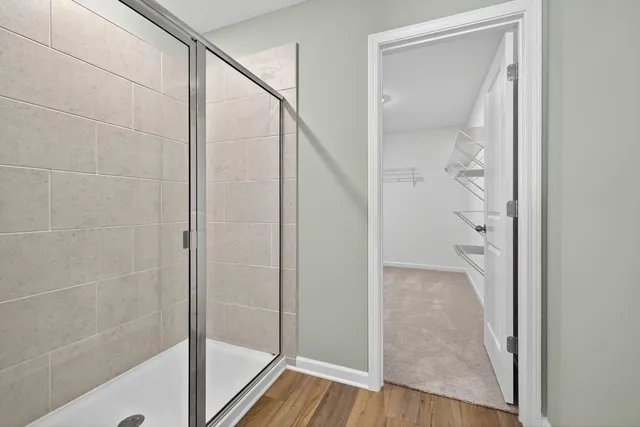 a bathroom with a glass shower door and mirror