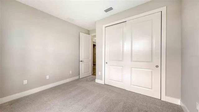 a view of an empty room with closet area