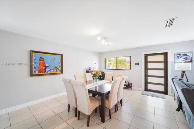 a view of a dining room with furniture and chandelier