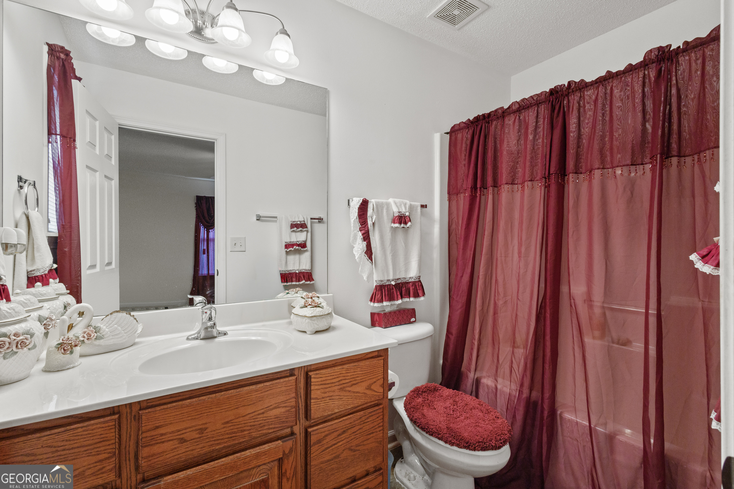 1275 Ross St Lane Macon, GA 31201 - Photo 12 of 20 a bathroom with a sink a toilet and mirror
