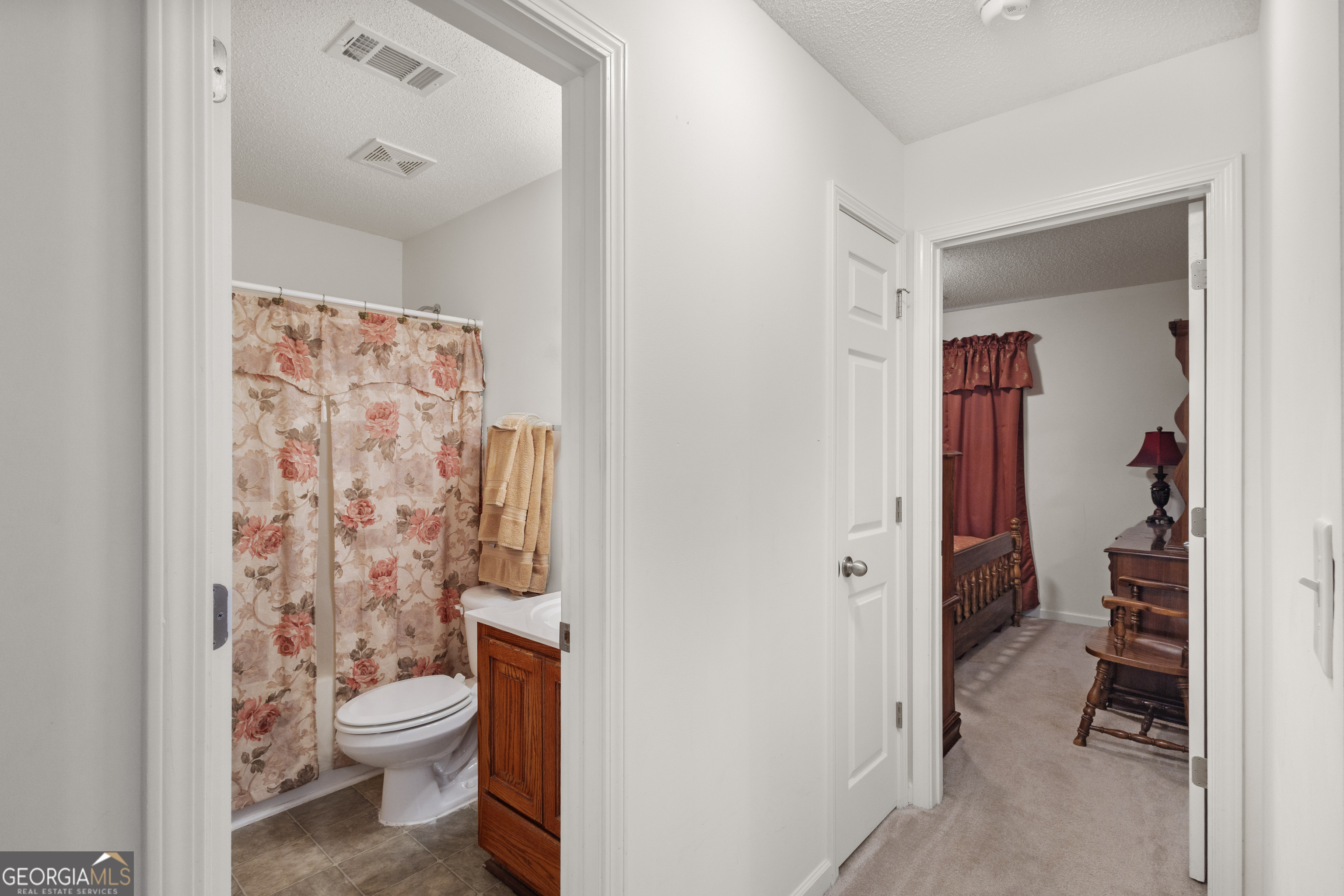 1275 Ross St Lane Macon, GA 31201 - Photo 14 of 20 a bathroom with a toilet and a shower curtain