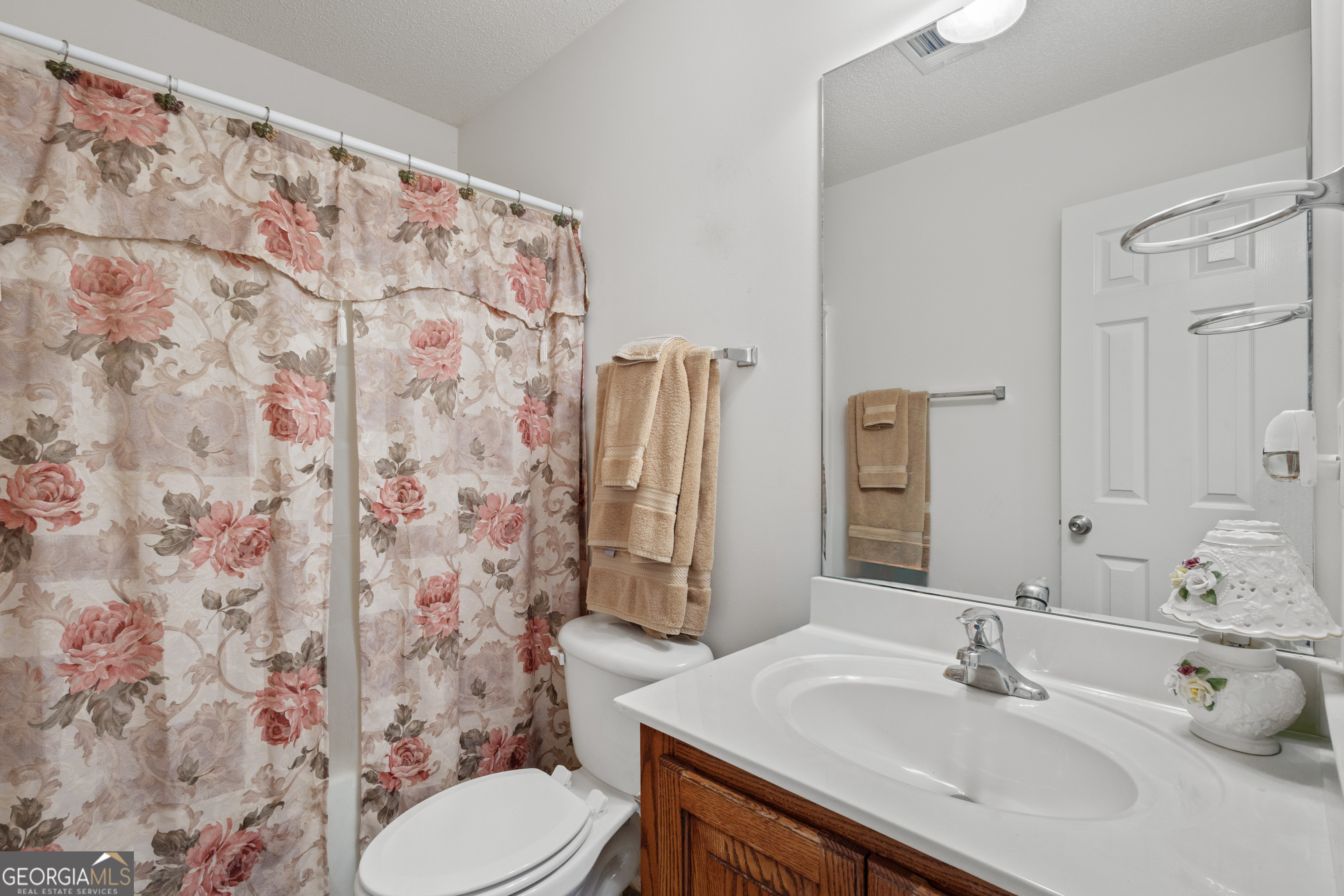 1275 Ross St Lane Macon, GA 31201 - Photo 16 of 20 a bathroom with a sink toilet and shower