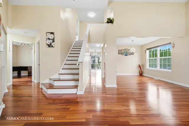 a view of entryway and hall with wooden floor